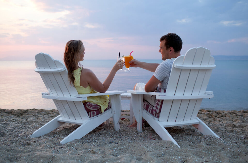 couple enjoying drinks on the beach - Enhancing Intimacy Through Communication