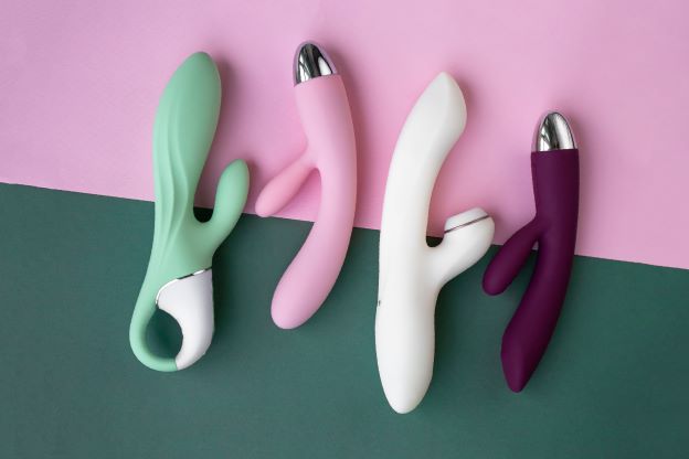 sex toys on green and pink background